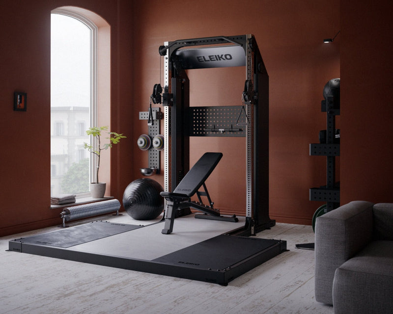 Modern home gym with fitness equipment against a red wall.