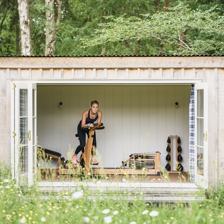 Person using a nohrd wooden equipment in a wooden cabin surrounded by nature