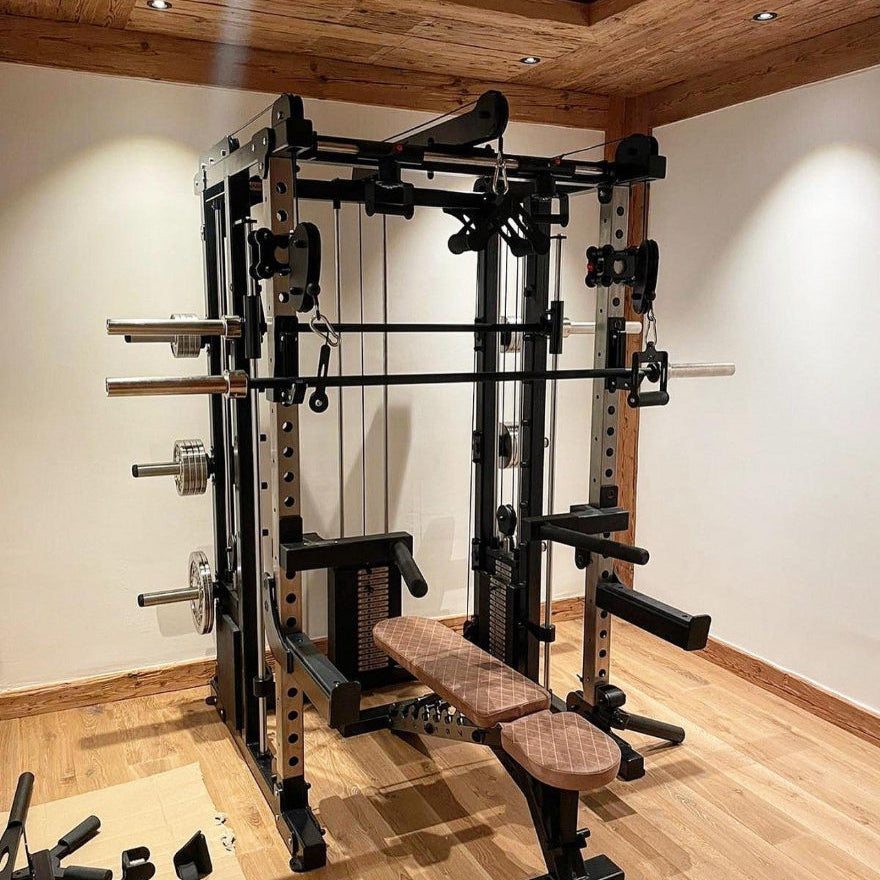 Gym equipment in a home gym setting with wooden flooring and white walls.
